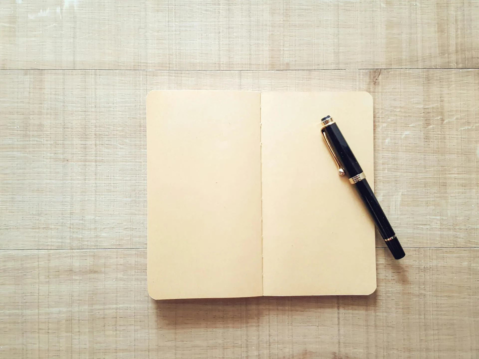 Open notebook on a wooden desk